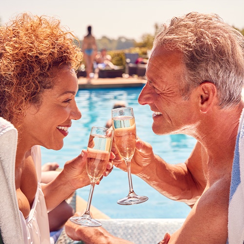 happy senior couple on vacation reasonable rate of return saving for retirement