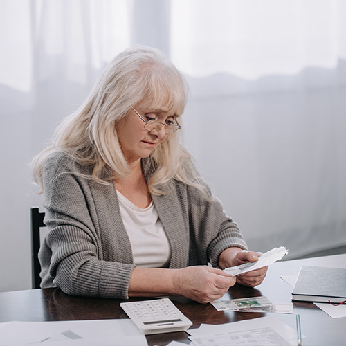 senoir woman counting money saving for retirement